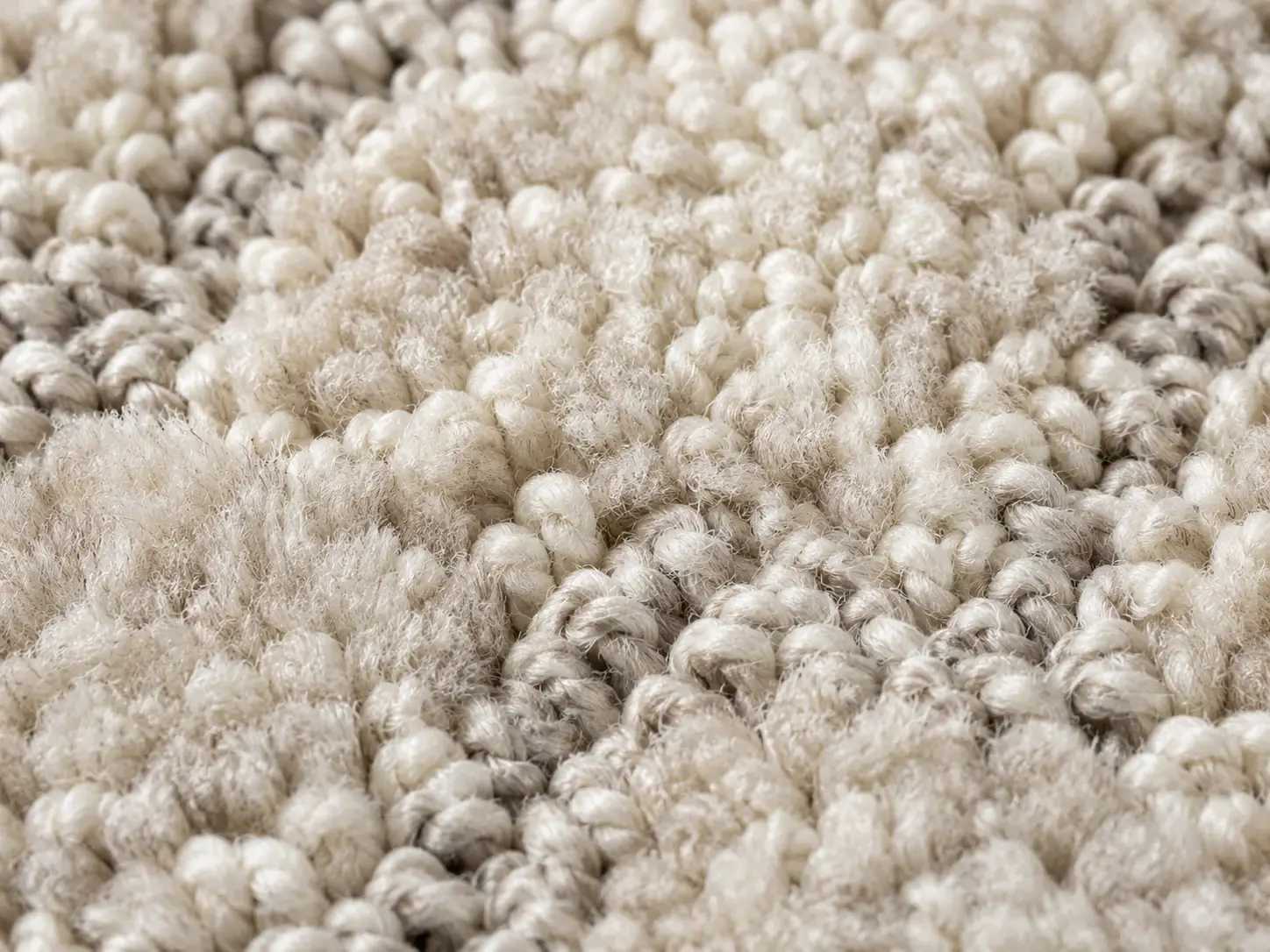 Macro close-up of hand tufted wool carpet pile, cut and loop texture